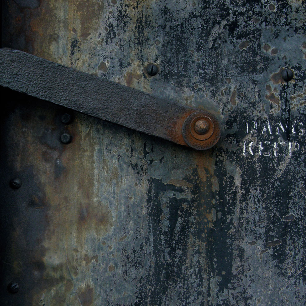metal door detail with danger, keep out, photographed by louise häggberg